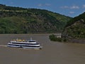 Excursion passenger vessel Vater Rhein with tourists on deck enjoying the sunny day on Rhine river with beautiful landscape.