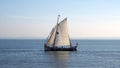 Excursion sailboat flying Portuguese flag underway in the Tagus estuary off the coast in Lisbon