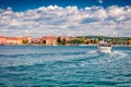 Excursion on tourist motorboat on Adriatic Sea. Sunny summer cityscape of popular summer resort - Porec.