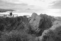 Excursionists visiting cliffs and coves on a stormy day in Porto Covo, Portugal