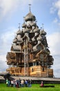 Excurtion group looking at wooden church at Kizhi under reconstruction Royalty Free Stock Photo