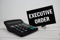 Excutive Order text message with calculate on wooden background Royalty Free Stock Photo