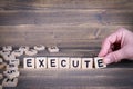 Execute. Wooden letters on the office desk