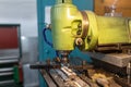 Execution of the work process on an industrial milling machine. The metal part is clamped in the collet. The cutter makes a Royalty Free Stock Photo