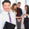 Executive asian boss with his business team at background Royalty Free Stock Photo