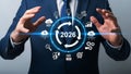 Businessman presenting the year 2026 with digital technology symbols and futuristic presentation for business growth Royalty Free Stock Photo