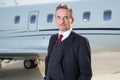 Executive business man in front of corporate jet Royalty Free Stock Photo