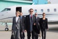 Executive business team leaving corporate jet Royalty Free Stock Photo