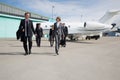 Executive business team leaving corporate jet