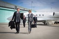 Executive business team leaving corporate jet Royalty Free Stock Photo