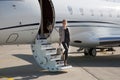 A executive business woman leaving a plane Royalty Free Stock Photo