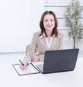 Executive business woman writing on a blak sheet.