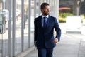 Executive businessman. Portrait of ceo near modern office in suit. Happy leader standing in front of company building. Royalty Free Stock Photo