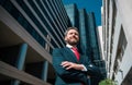 Executive businessman. Portrait of ceo near modern office in suit. Happy leader standing in front of company building. Royalty Free Stock Photo