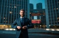 Executive businessman. Portrait of ceo near modern office in suit. Happy leader standing in front of company building. Royalty Free Stock Photo