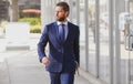 Executive businessman. Portrait of ceo near modern office in suit. Happy leader standing in front of company building. Royalty Free Stock Photo