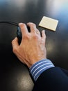 Executive hand handling the mouse with yellow paper Royalty Free Stock Photo