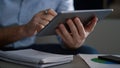 Executive hands using tablet digital device browsing network data in office. Royalty Free Stock Photo