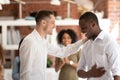 Executive manager congratulating African American employee at meeting Royalty Free Stock Photo