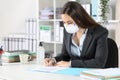 Executive with mask signing contract at office Royalty Free Stock Photo