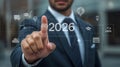 Businessman Activating Futuristic Interface Displaying 2026 with Business Icons and Digital Technology Ready for the Future Royalty Free Stock Photo