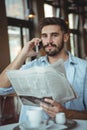 Executive talking on mobile phone in cafÃÆÃÂ© Royalty Free Stock Photo