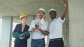 Executive team on construction site discussing project, using smartpone and digital tablet Royalty Free Stock Photo