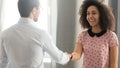 Executive, team leader shaking hand of successful diverse smiling employee Royalty Free Stock Photo