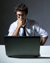 Executive thinking in front of his laptop Royalty Free Stock Photo