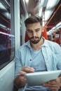 Executive using digital tablet travelling in train Royalty Free Stock Photo