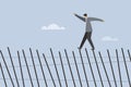 A business executive takes the risk of walking over a collapsing fence