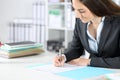 Executive woman filling out form at the office Royalty Free Stock Photo