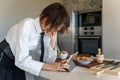Executive woman looking at a recipe on a tablet, standing in the kitchen Royalty Free Stock Photo
