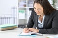 Executive woman writing notes on agenda at office Royalty Free Stock Photo