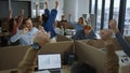 Executives celebrating good work results in office. Colleagues raising hands Royalty Free Stock Photo