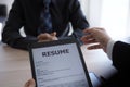 Executives are interviewing candidates and holding a tablet, opening the resume from the email that the applicant submits online. Royalty Free Stock Photo