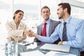 Executives shaking hands in board room meeting Royalty Free Stock Photo