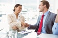 Executives shaking hands in board room meeting Royalty Free Stock Photo