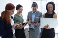 Executives using mobile phone, laptop and digital tablet in the office Royalty Free Stock Photo