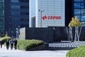 Executives walking next to the Cepsa logo in the Cepsa Tower.
