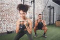 Exercise benefits more than just your body. two sporty young people using kettlebells while working out at the gym. Royalty Free Stock Photo