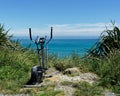 Exercise bike dumped in a layby overlooking the ocean, a gym with a view, west coast, south island, New Zealand