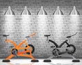 Exercise bike with light spotlight on brick wall texture background Royalty Free Stock Photo