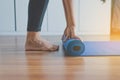 Exercise equipment,Woman hand rolling or folding yoga mat after a workout