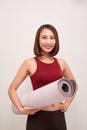 Exercise fitness woman ready for workout standing holding yoga mat Royalty Free Stock Photo