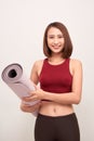 Exercise fitness woman ready for workout standing holding yoga mat Royalty Free Stock Photo