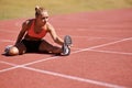 Exercise, legs and woman stretching in stadium for race, marathon or competition training for health. Sports, runner and Royalty Free Stock Photo