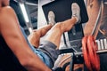 Exercise, man and legs workout in gym, with machine and training for wellness, health and fitness in sportswear. Male Royalty Free Stock Photo