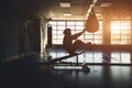 Exercise men endurance strength training in the gym. Silhouette shot in front of the window