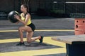 Exercise. Sport woman doing leg workout with med ball outdoors